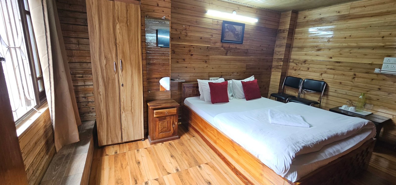 Luxury hotel room near Mall Road Darjeeling with wooden interiors and modern amenities